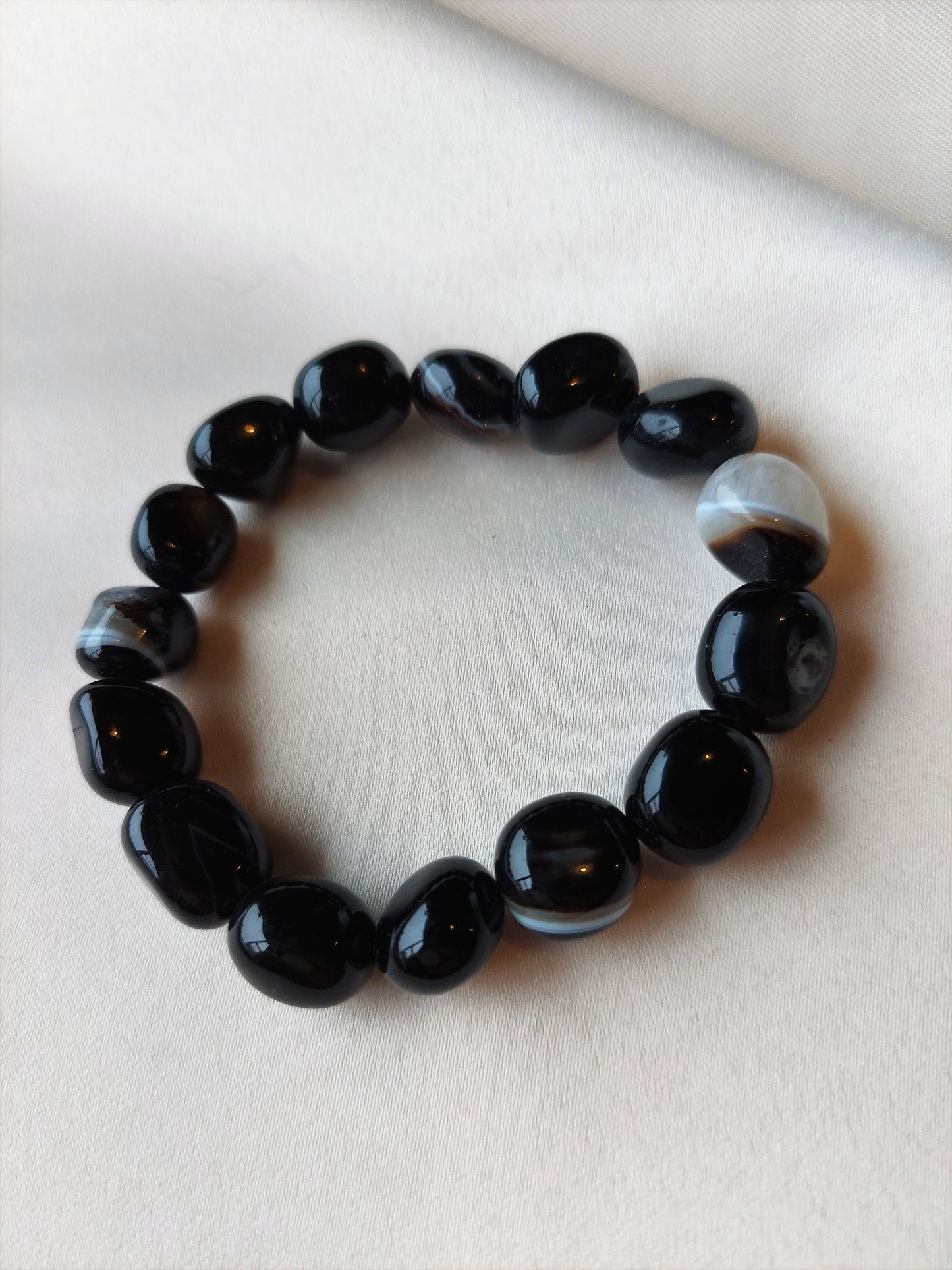 Botswana Agate. Black bracelet with white banding through it. Bracelet is elastic.