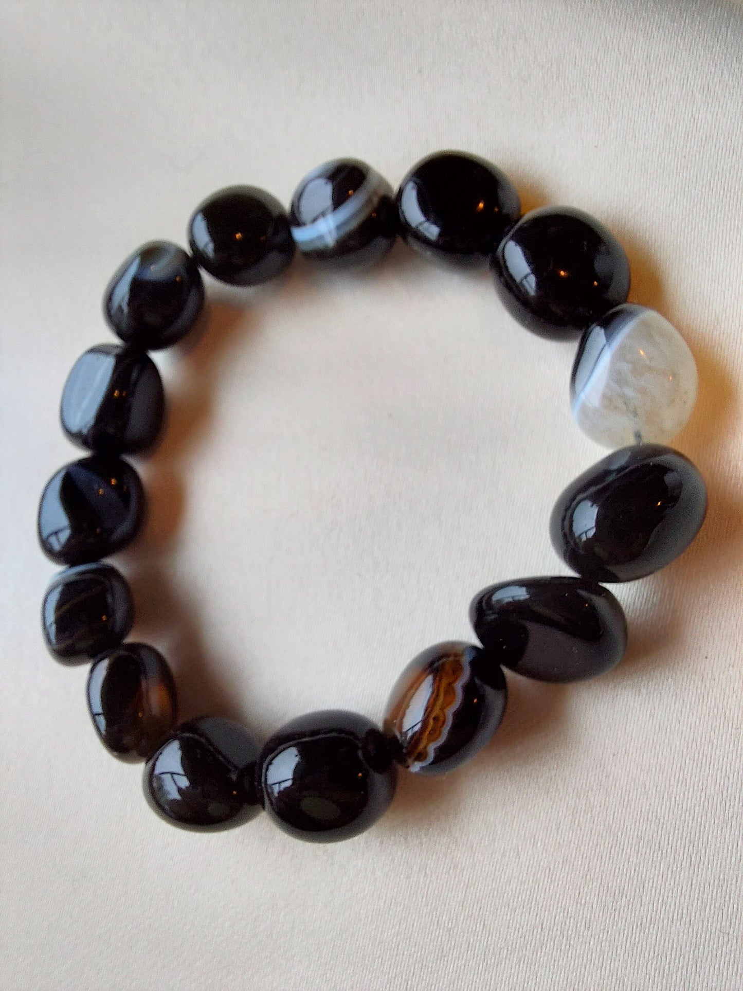 Botswana Agate. Black bracelet with white banding through it. Bracelet is elastic.