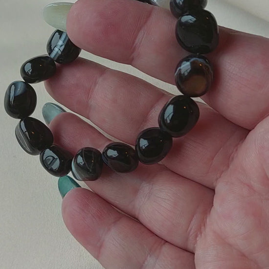 Botswana Agate. Black bracelet with white banding through it. Bracelet is elastic.