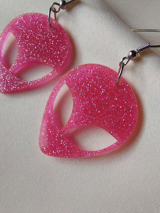 Pink glitter alien head earrings. Hanging on with silver earring hooks. 