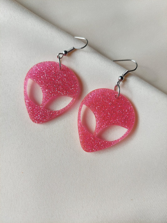 Pink glitter alien head earrings. Hanging on with silver earring hooks. 